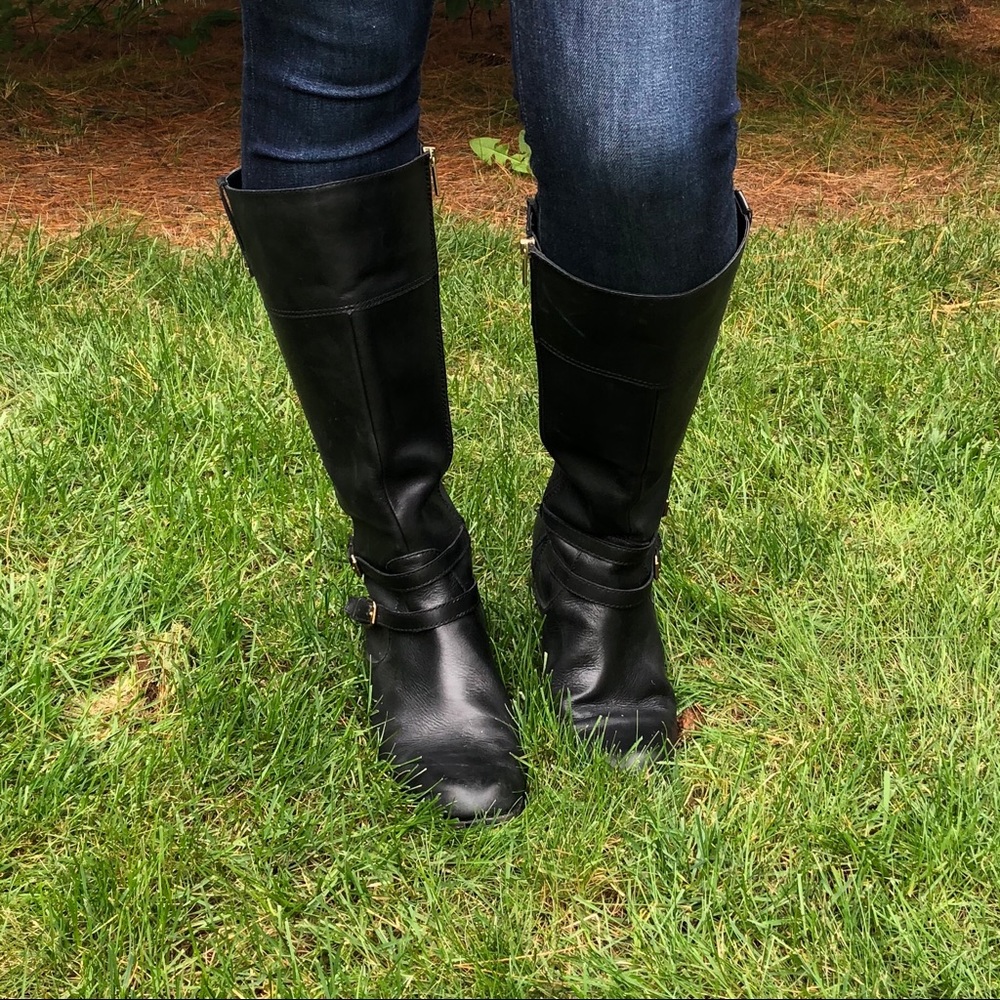 Black leather riding boots with gold buckles